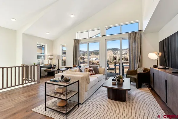 a living room with furniture or couch and a wooden floor