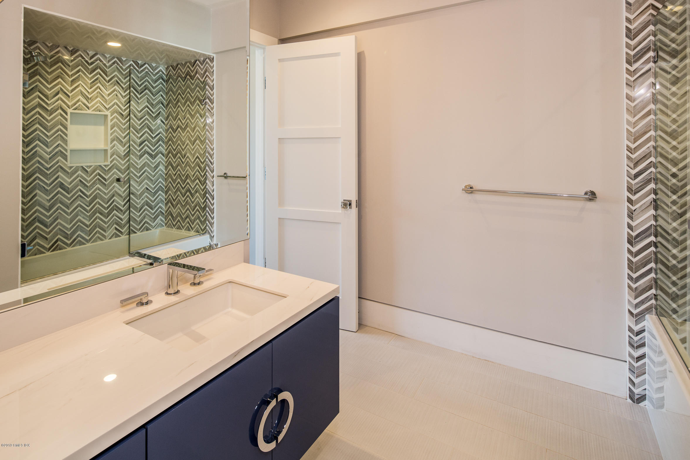 38 St Roch Avenue, Unit E Greenwich, CT 06830 - Photo 17 of 51 a bathroom with a sink a shower and a mirror