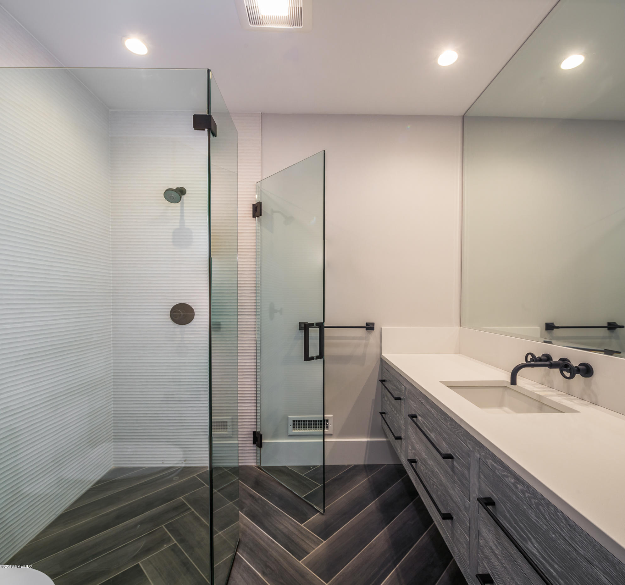 38 St Roch Avenue, Unit E Greenwich, CT 06830 - Photo 21 of 51 a bathroom with a sink and a shower