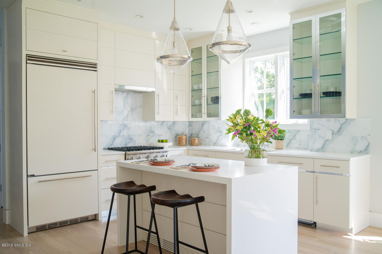 38 St Roch Avenue, Unit E Greenwich, CT 06830 - Photo 3 of 51 a kitchen with a table and chairs in it