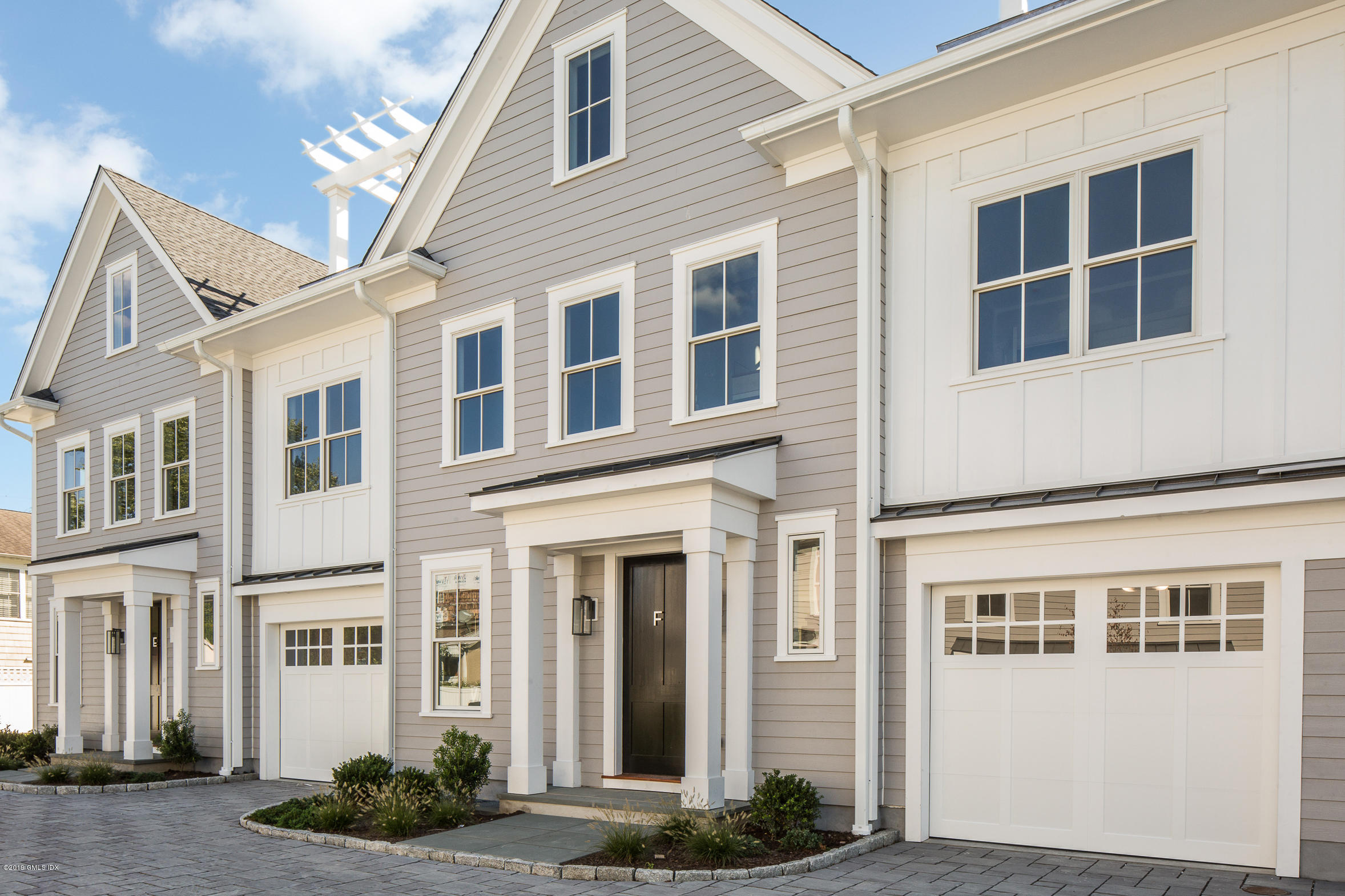 38 St Roch Avenue, Unit E Greenwich, CT 06830 - Photo 38 of 51 a front view of a building with a yard