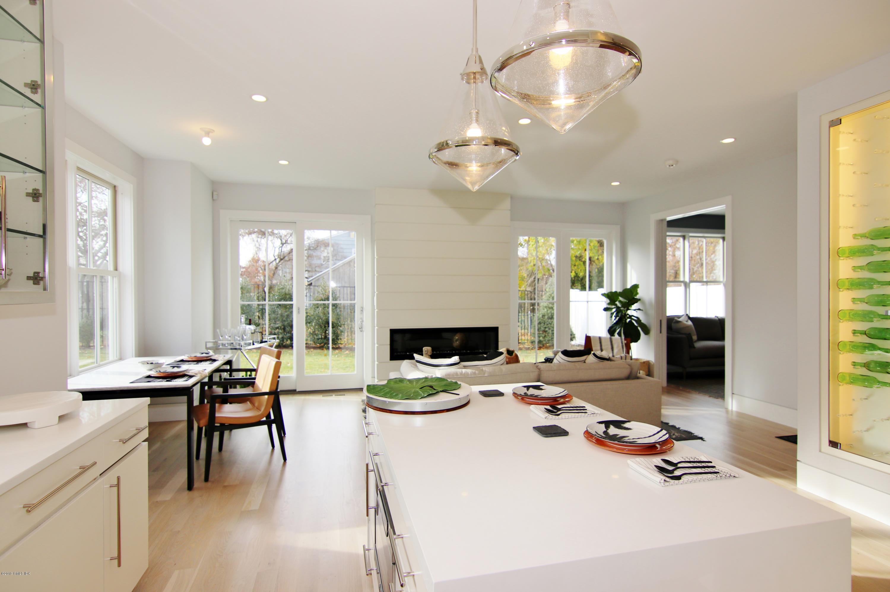 38 St Roch Avenue, Unit E Greenwich, CT 06830 - Photo 40 of 51 a living room with fireplace furniture and a large window
