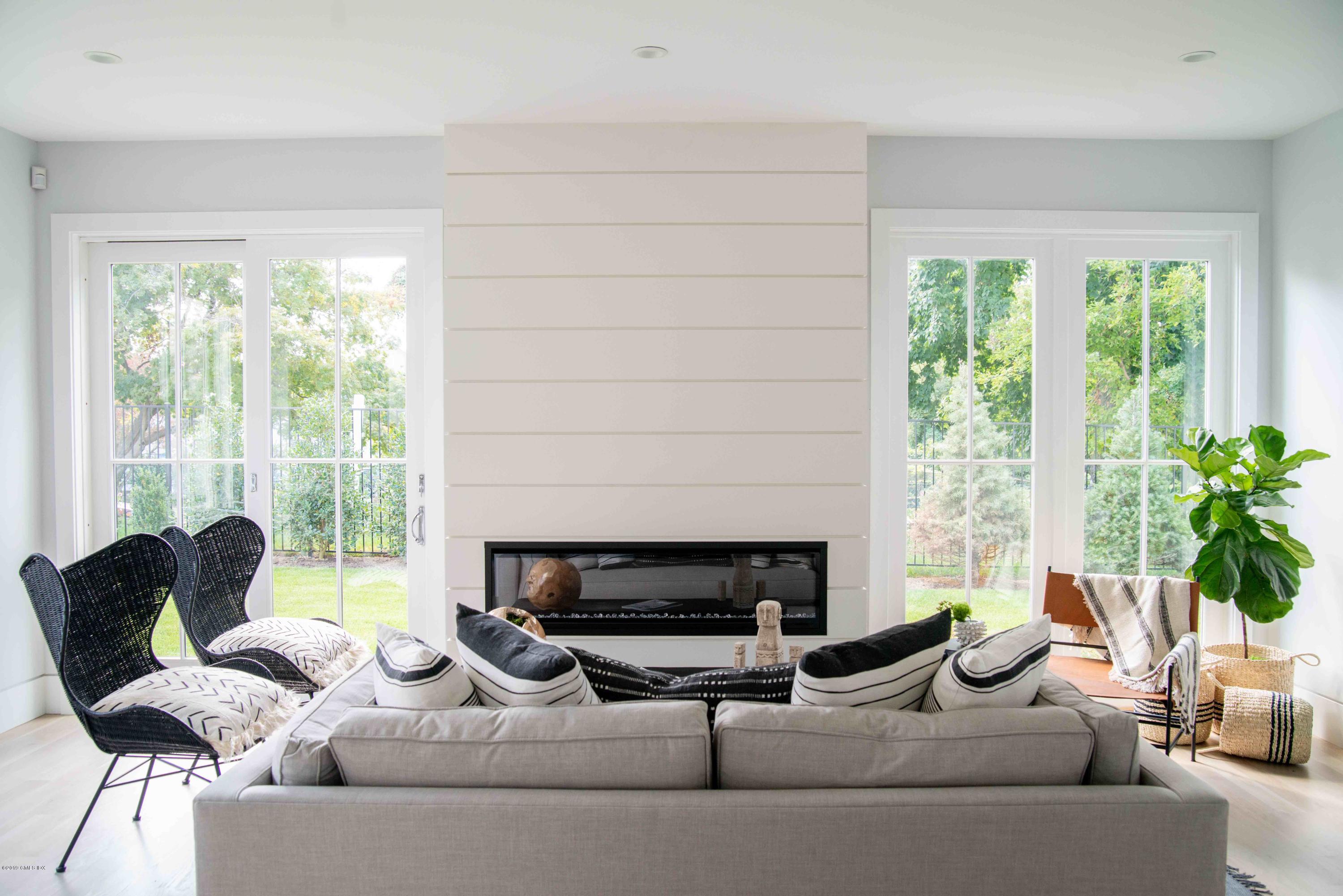 38 St Roch Avenue, Unit E Greenwich, CT 06830 - Photo 4 of 51 a living room with furniture and a fireplace