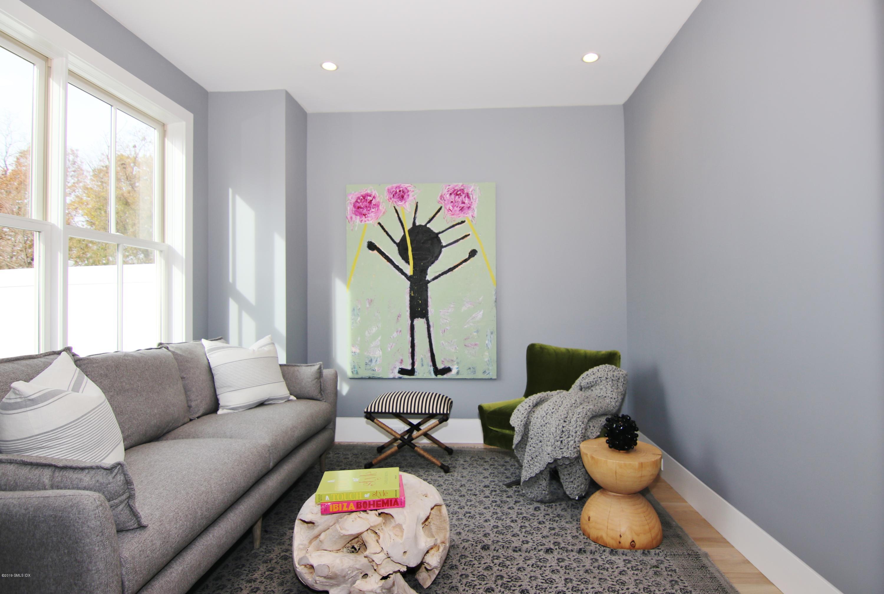 38 St Roch Avenue, Unit E Greenwich, CT 06830 - Photo 41 of 51 a living room with furniture and a large window