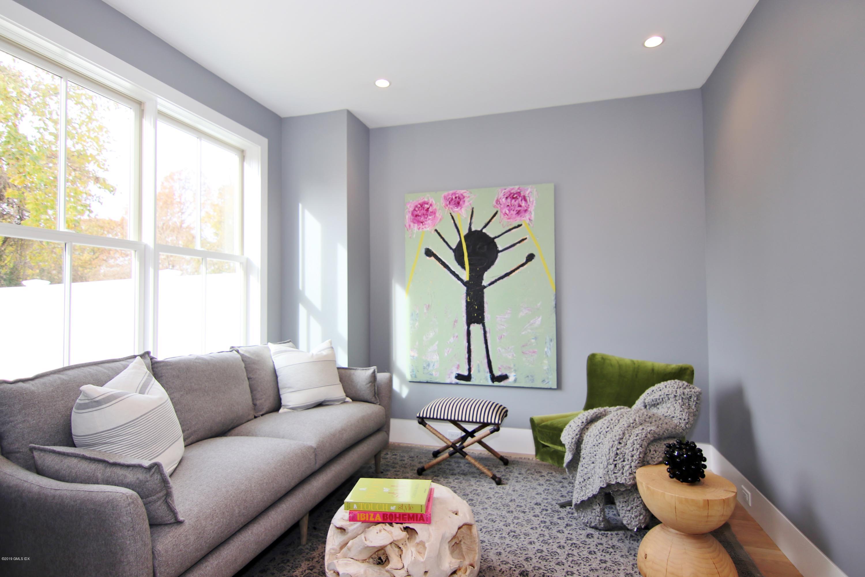 38 St Roch Avenue, Unit E Greenwich, CT 06830 - Photo 42 of 51 a living room with furniture and a large window