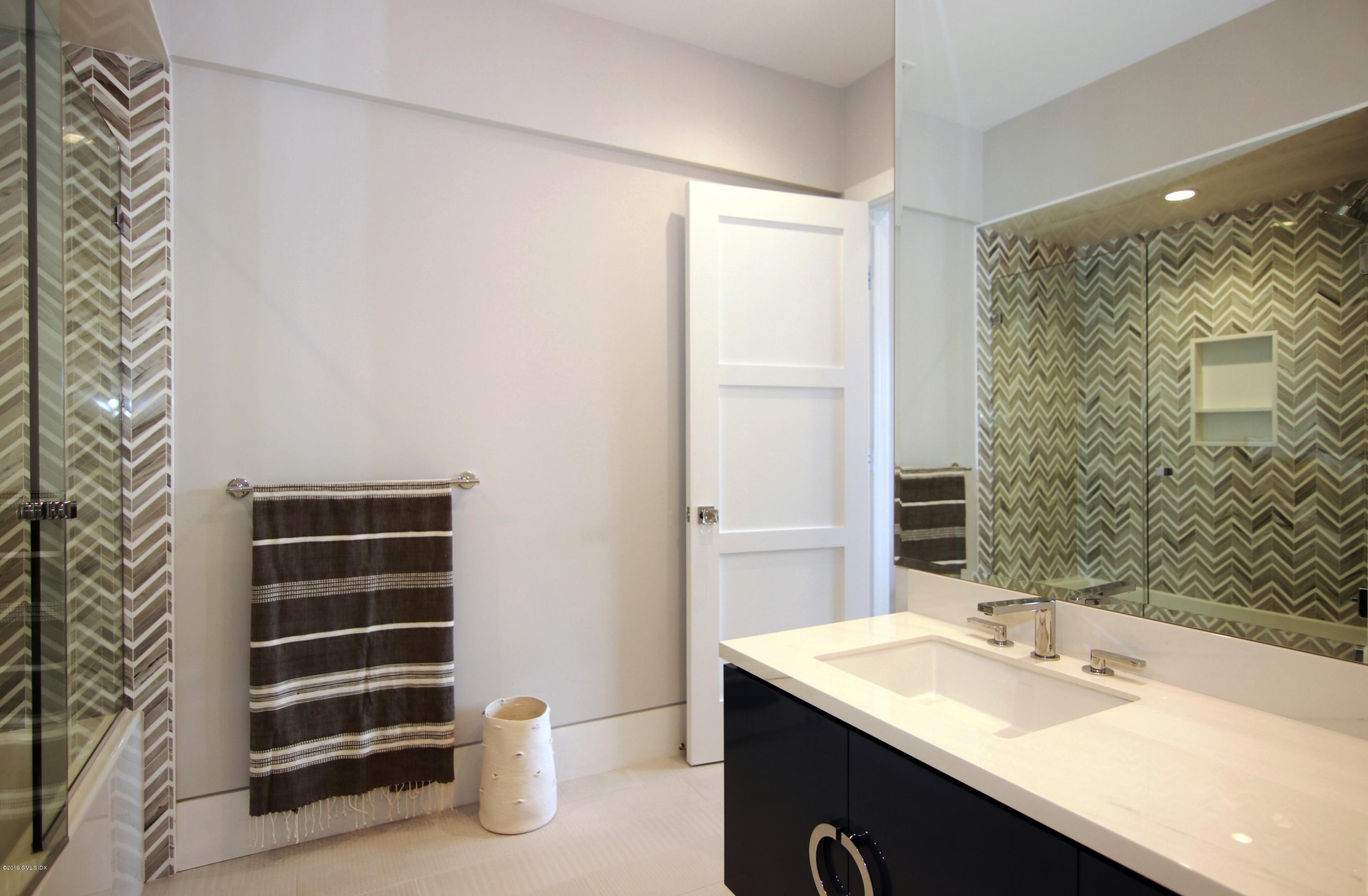 38 St Roch Avenue, Unit E Greenwich, CT 06830 - Photo 46 of 51 a bathroom with a sink and a mirror