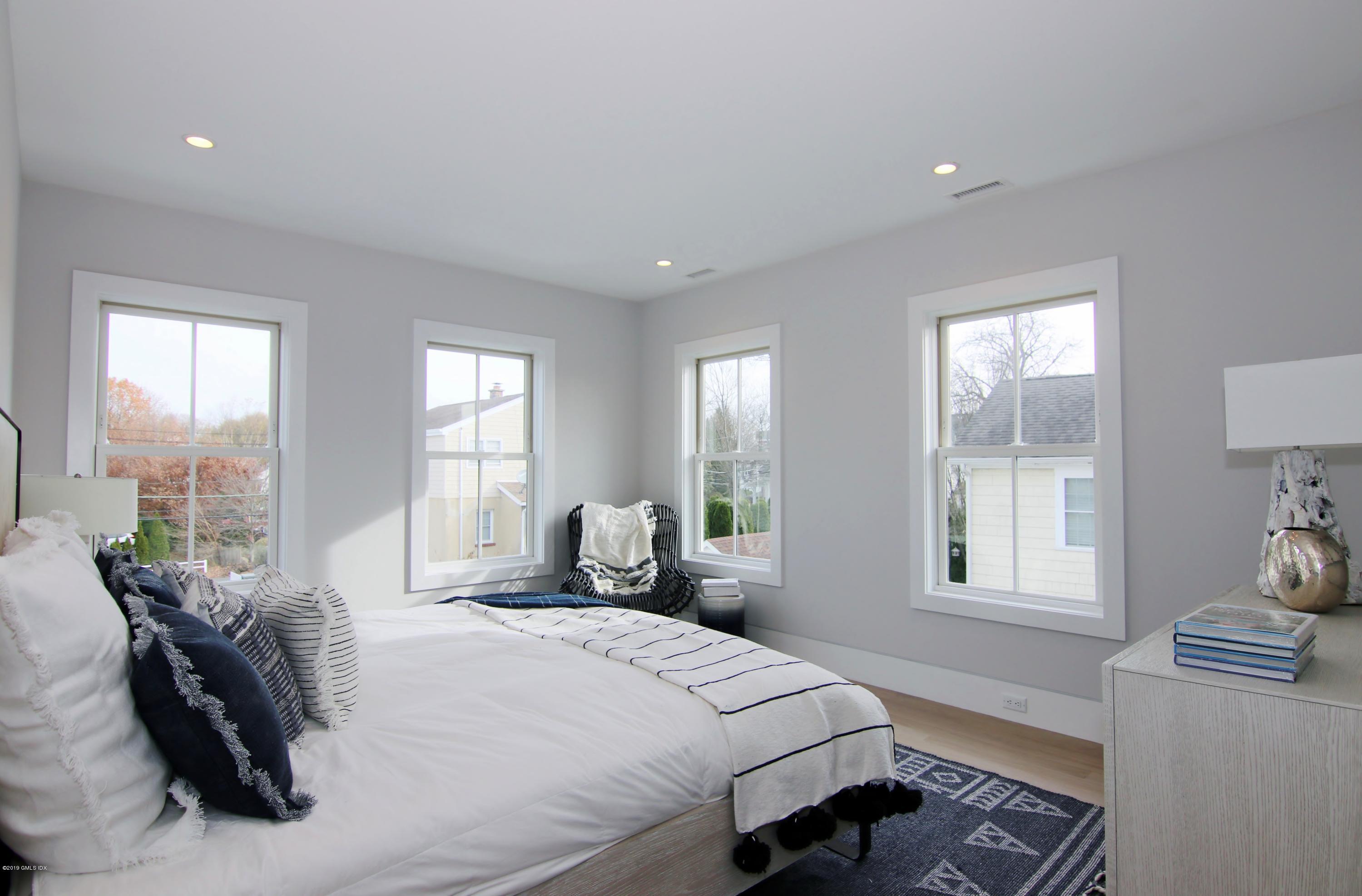 38 St Roch Avenue, Unit E Greenwich, CT 06830 - Photo 47 of 51 a bedroom with a bed and wooden floor