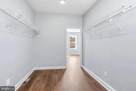 a view of a room with wooden floor and white walls