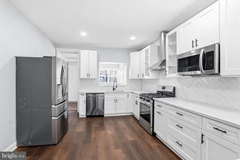 a kitchen with stainless steel appliances a refrigerator stove and microwave
