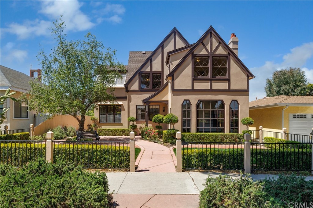 323 South H Street Lompoc, CA 93436 - Photo 1 of 1 a front view of a house with a yard and potted plants