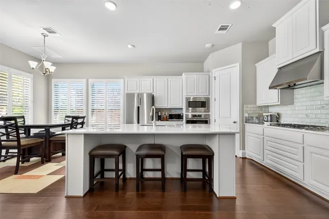 a kitchen with stainless steel appliances a stove a microwave and cabinets