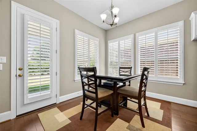 a living room with furniture ceiling fan and a wooden floor