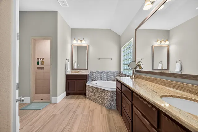 a bathroom with a bathtub and a shower