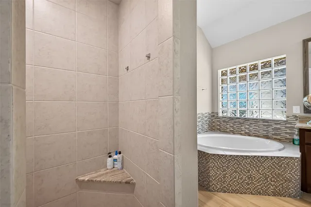 a bathroom with a granite countertop sink toilet a mirror and shower
