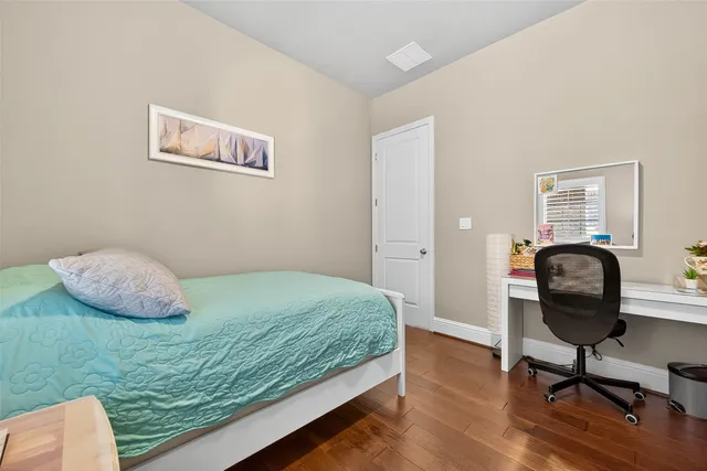 a bedroom with a bed and a desk