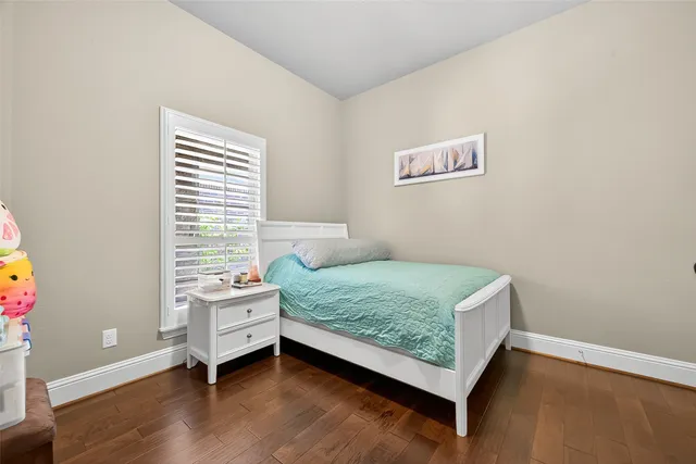 a bedroom with a bed and a dresser