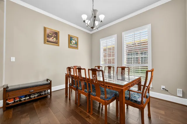 a dining room with furniture and wooden floor