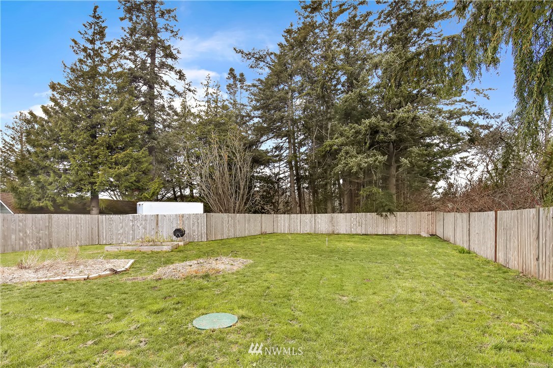 1606 Bayon Road Bellingham, WA 98225 - Photo 34 of 39 a view of a swimming pool with a small yard and large trees