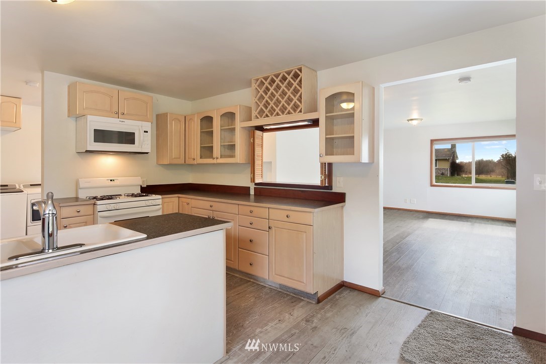 1606 Bayon Road Bellingham, WA 98225 - Photo 7 of 39 a kitchen with stainless steel appliances granite countertop a sink stove and microwave
