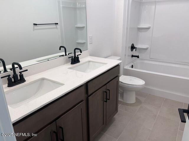 1177 Brk Frst Drive St. Augustine, FL 32092 - Photo 19 of 31 a bathroom with a double vanity sink a toilet and a bathtub