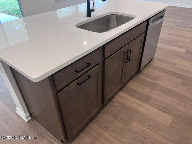 1177 Brk Frst Drive St. Augustine, FL 32092 - Photo 7 of 31 a kitchen with kitchen island sink and wooden floor