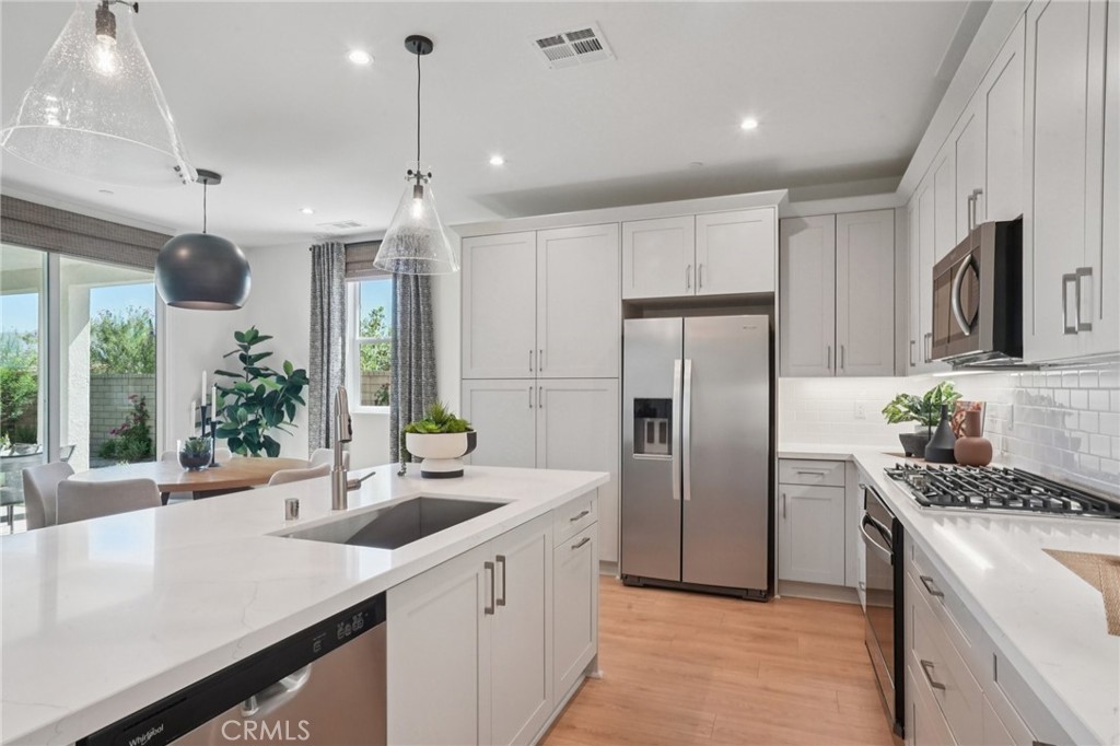 73634 Raphael Drive Palm Desert, CA 92211 - Photo 12 of 42 a kitchen with refrigerator a sink and cabinets