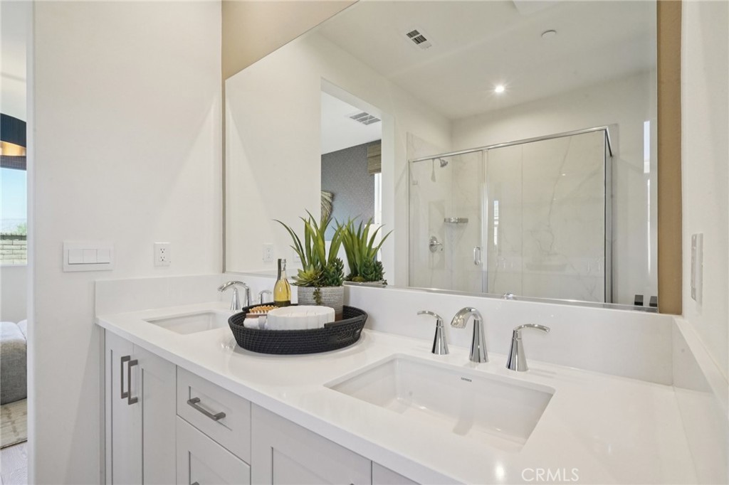 73634 Raphael Drive Palm Desert, CA 92211 - Photo 22 of 42 a bathroom with a sink a faucet a potted plant and a mirror