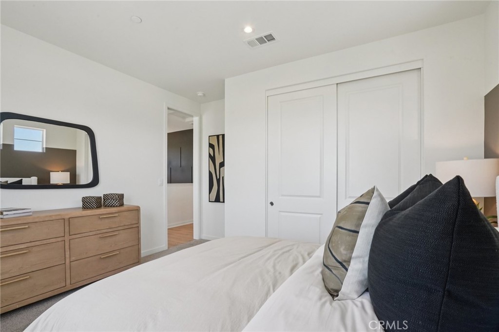 73634 Raphael Drive Palm Desert, CA 92211 - Photo 26 of 42 a bedroom with a bed and a mirror