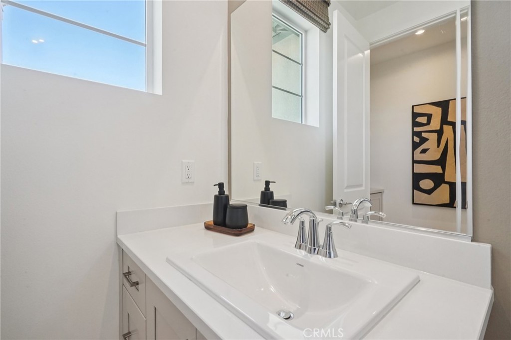 73634 Raphael Drive Palm Desert, CA 92211 - Photo 28 of 42 a bathroom with a sink and a mirror
