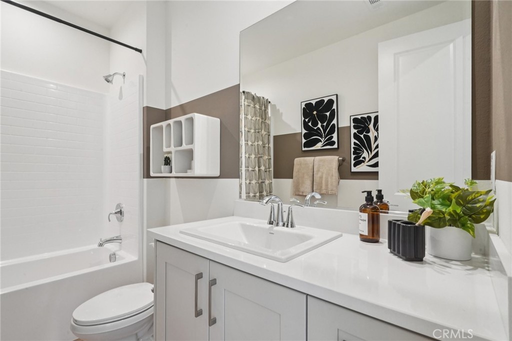 73634 Raphael Drive Palm Desert, CA 92211 - Photo 31 of 42 a bathroom with a granite countertop sink a toilet and shower
