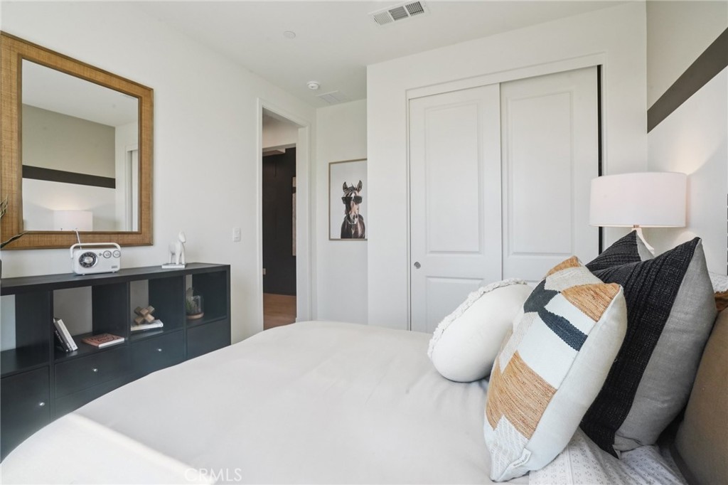 73634 Raphael Drive Palm Desert, CA 92211 - Photo 34 of 42 a bedroom with a bed and a mirror