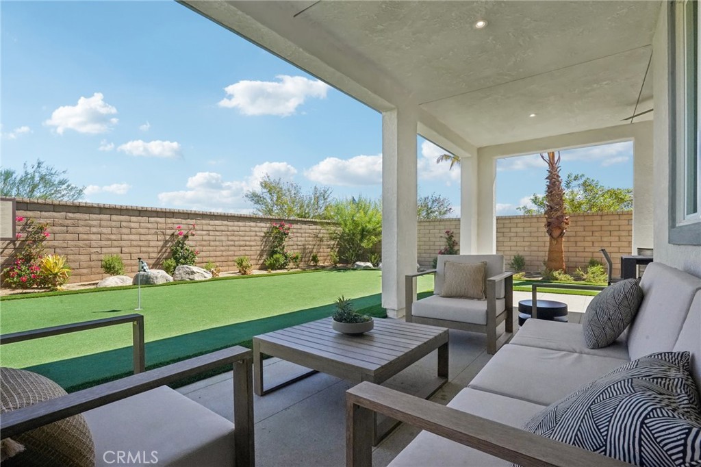 73634 Raphael Drive Palm Desert, CA 92211 - Photo 42 of 42 a living room with furniture and a large window