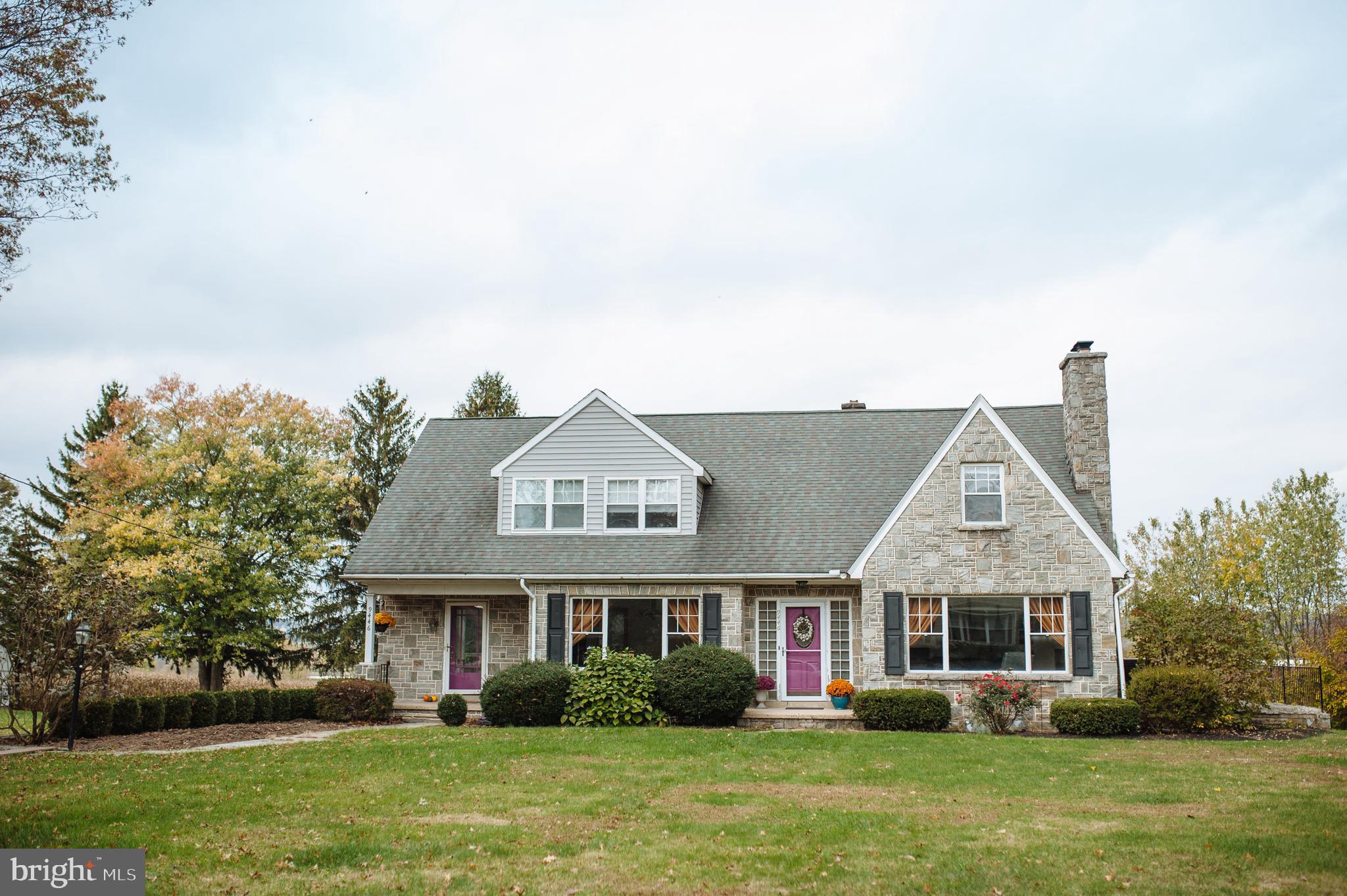 a front view of house with yard and green space