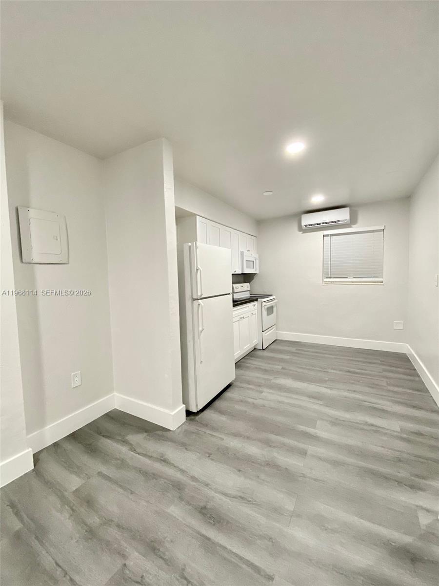 64 Northeast 78th Street, Unit 2 Miami, FL 33138 - Photo 8 of 11 a view of a kitchen with wooden floor and electronic appliances