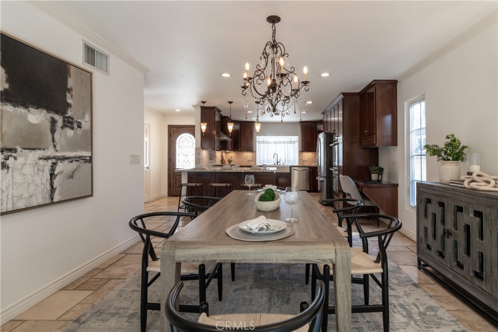 28009 Newbird Drive Saugus, CA 91350 - Photo 11 of 26 a view of a dining room with furniture a chandelier and wooden floor