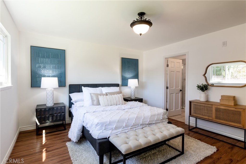 28009 Newbird Drive Saugus, CA 91350 - Photo 14 of 26 a bedroom with a bed a mirror and lamp