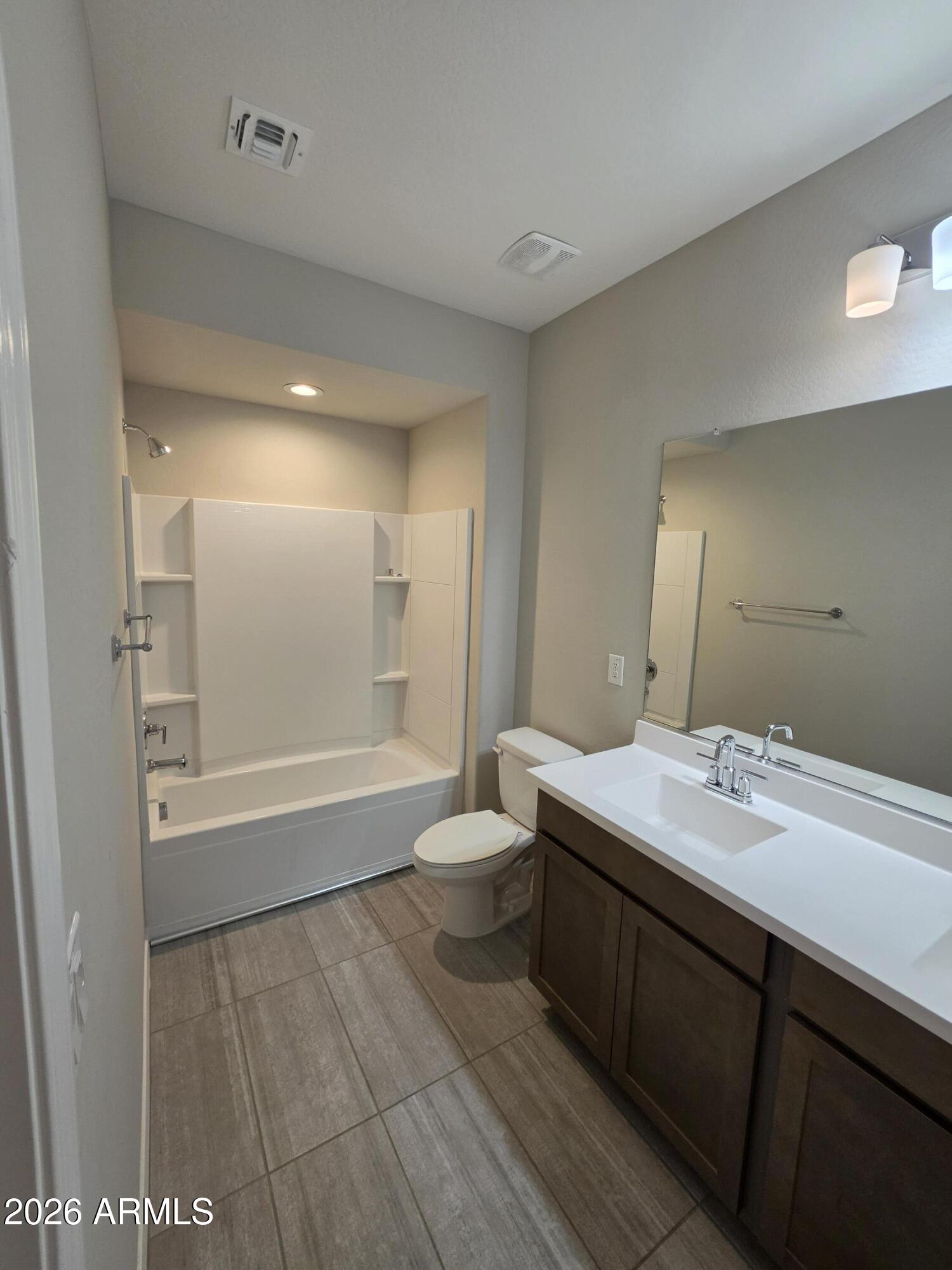 7128 West Coles Road Laveen, AZ 85339 - Photo 33 of 38 a bathroom with a sink a toilet a mirror and shower