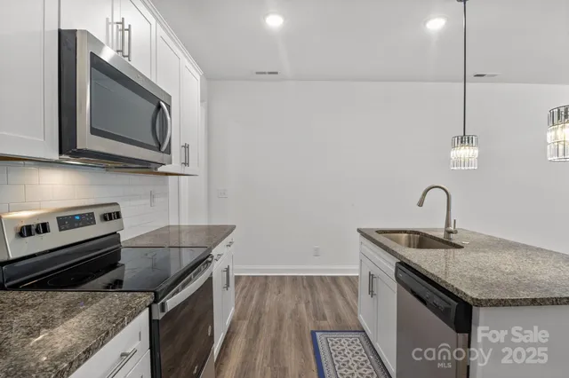 a kitchen that has a sink and a stove