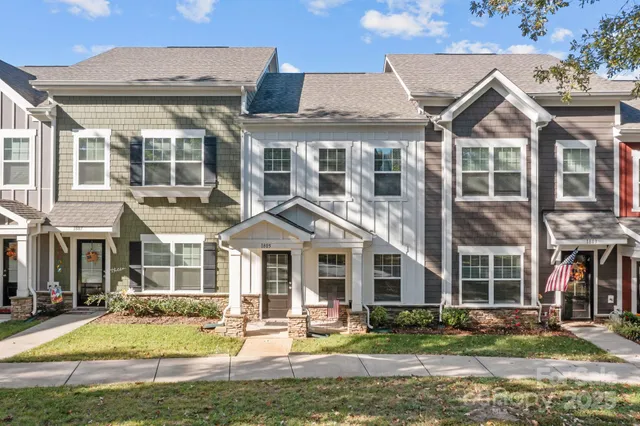 a front view of a residential apartment building with a yard