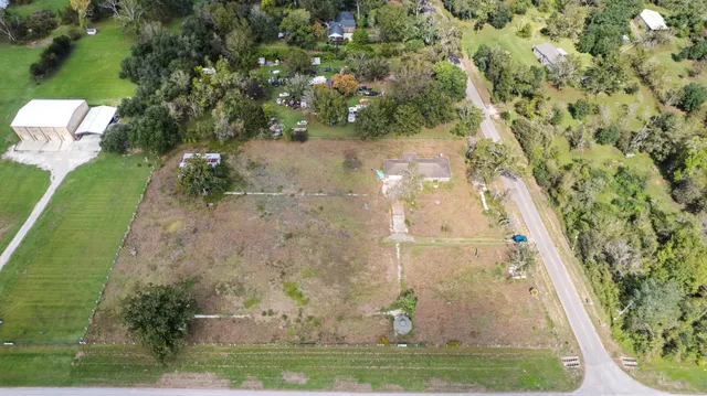 an aerial view of a residential houses with outdoor space