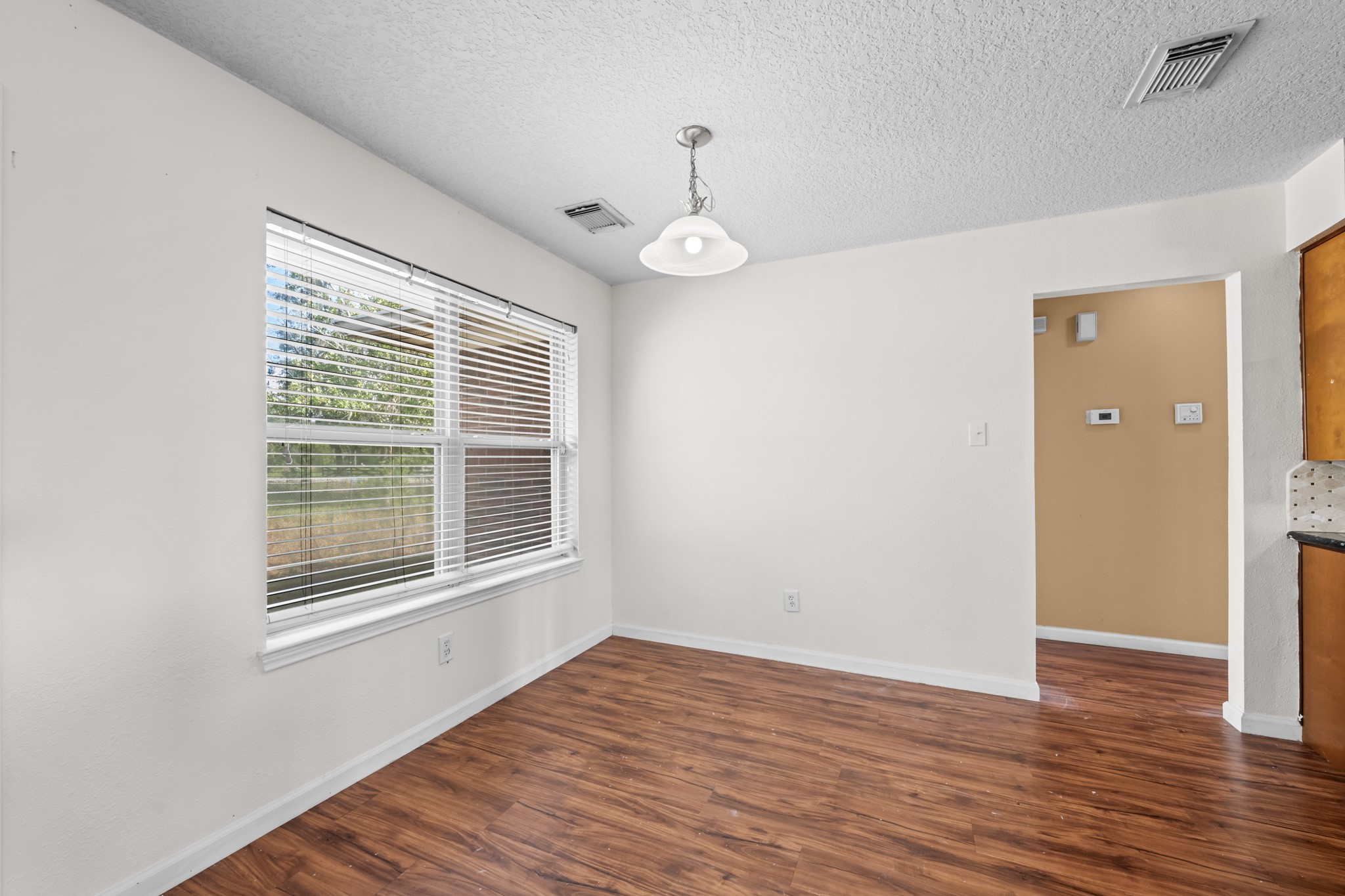 7442 County Road 42 Rosharon, TX 77583 - Photo 23 of 43 a view of an empty room with wooden floor and a window