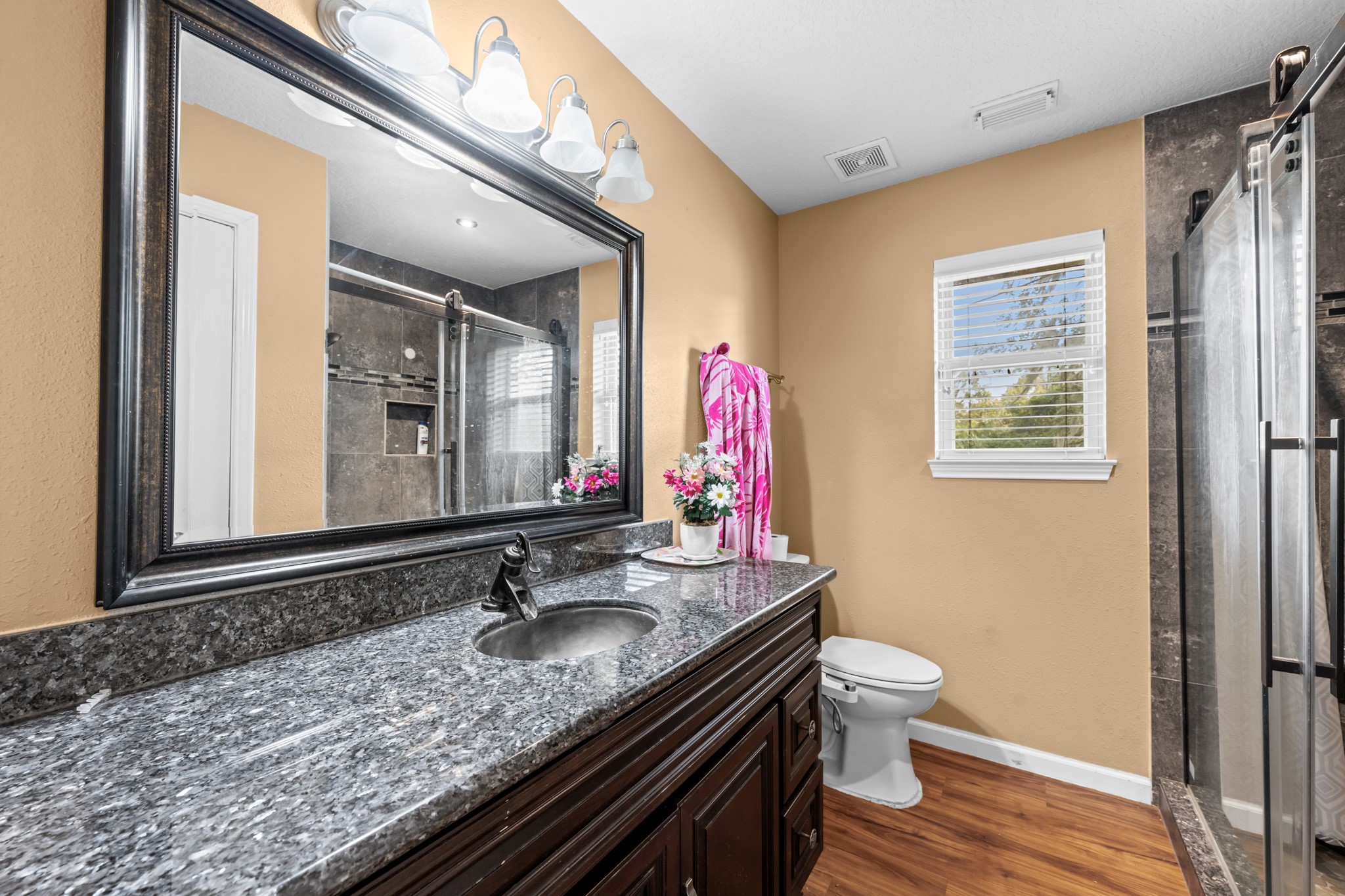 7442 County Road 42 Rosharon, TX 77583 - Photo 26 of 43 a bathroom with a granite countertop sink a mirror and a toilet