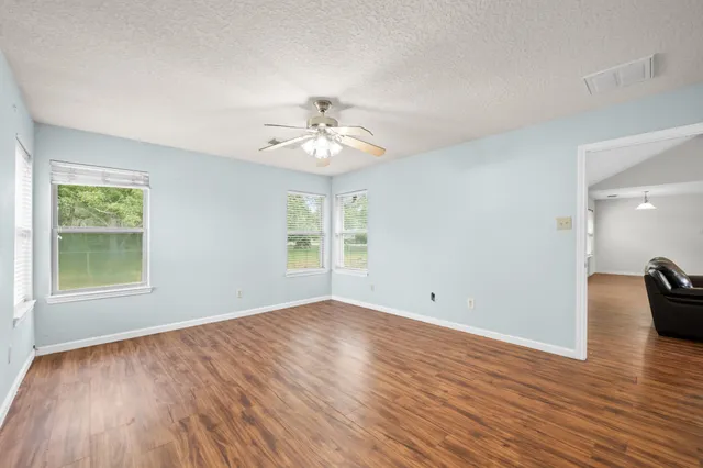wooden floor in an empty room with a window