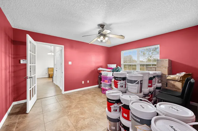 a living room with furniture and a floor to ceiling window