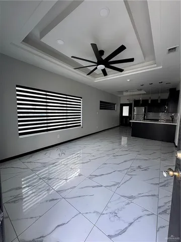 a view of a livingroom with a ceiling fan and window