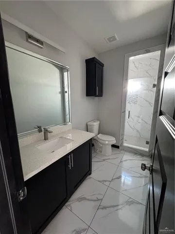 a bathroom with a double vanity sink mirror and bathtub