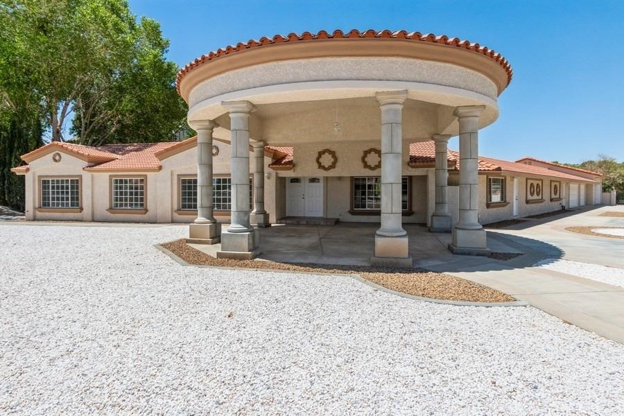 14982 Riverside Drive Apple Valley, CA 92307 - Photo 1 of 1 a front view of a house with a yard