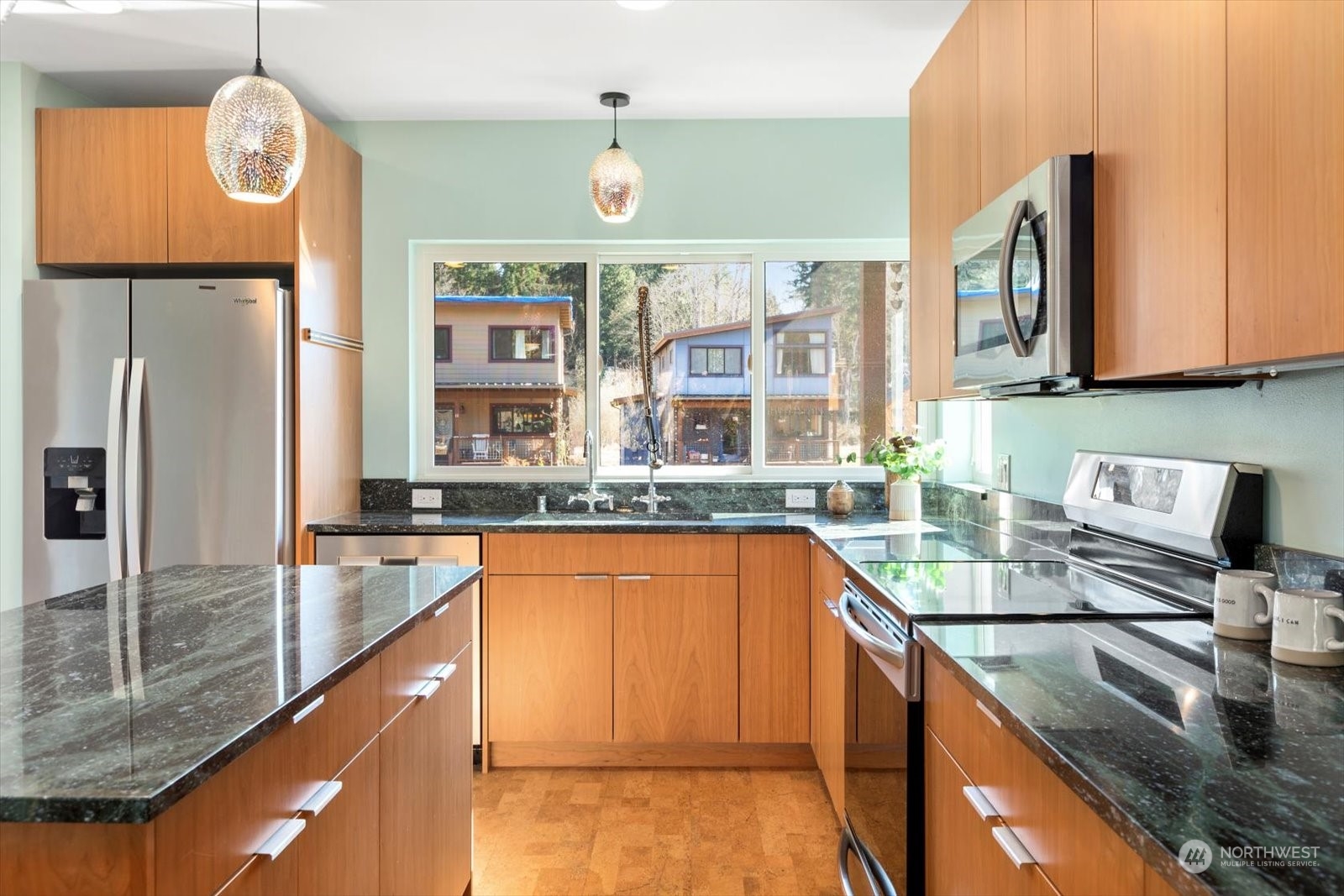 1402 194th Street Southeast, Unit 4 Bothell, WA 98012 - Photo 7 of 40 a kitchen with stainless steel appliances granite countertop a sink a stove and a refrigerator
