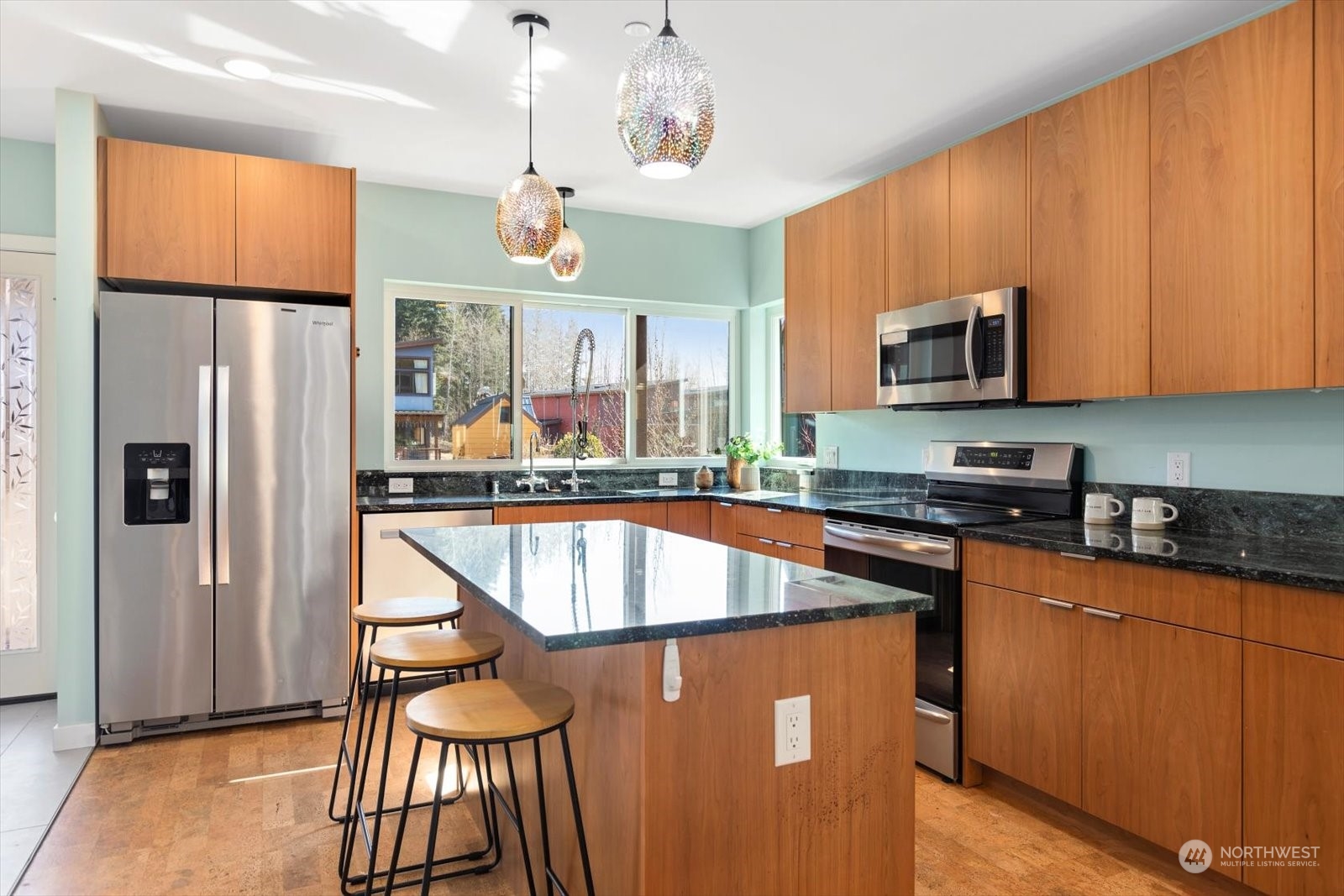1402 194th Street Southeast, Unit 4 Bothell, WA 98012 - Photo 9 of 40 a kitchen with stainless steel appliances granite countertop a refrigerator a microwave oven a sink dishwasher and white cabinets with wooden floor