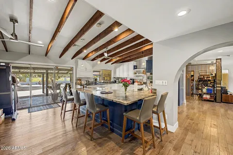 a dining room with furniture and wooden floor